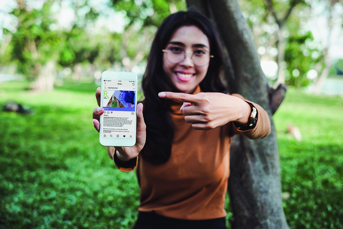 Rugby High School girl pointing at instagram